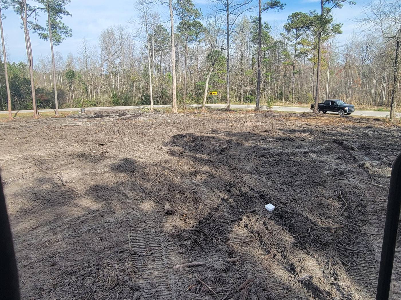 Cleared lot next to a paved road