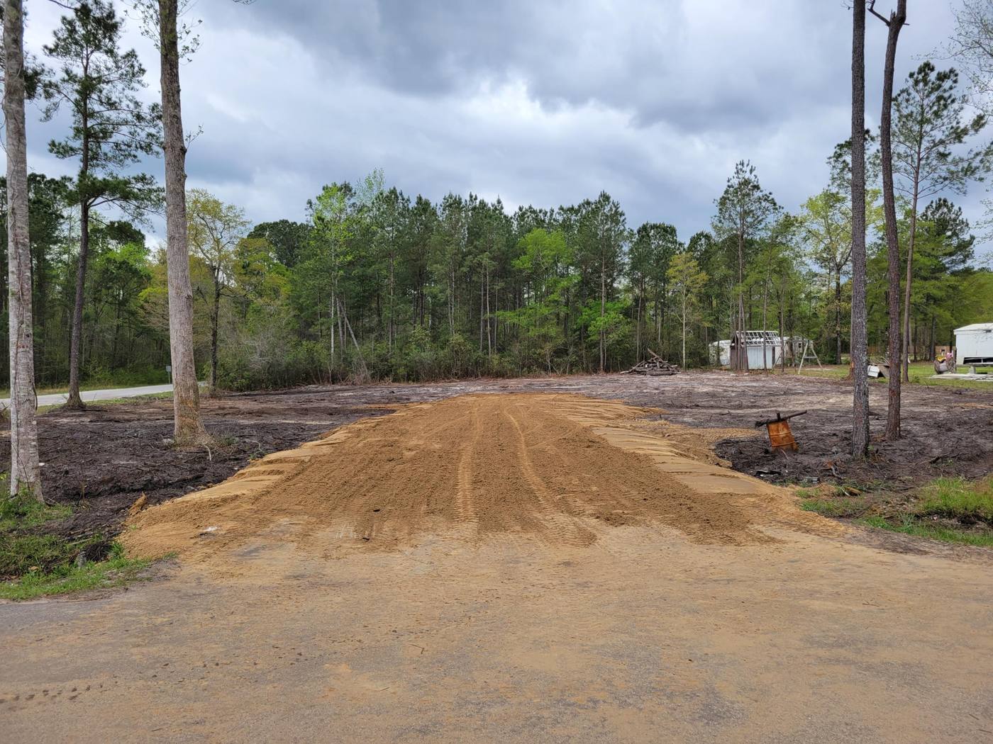 New driveway entrance built up with fill dirt from the road