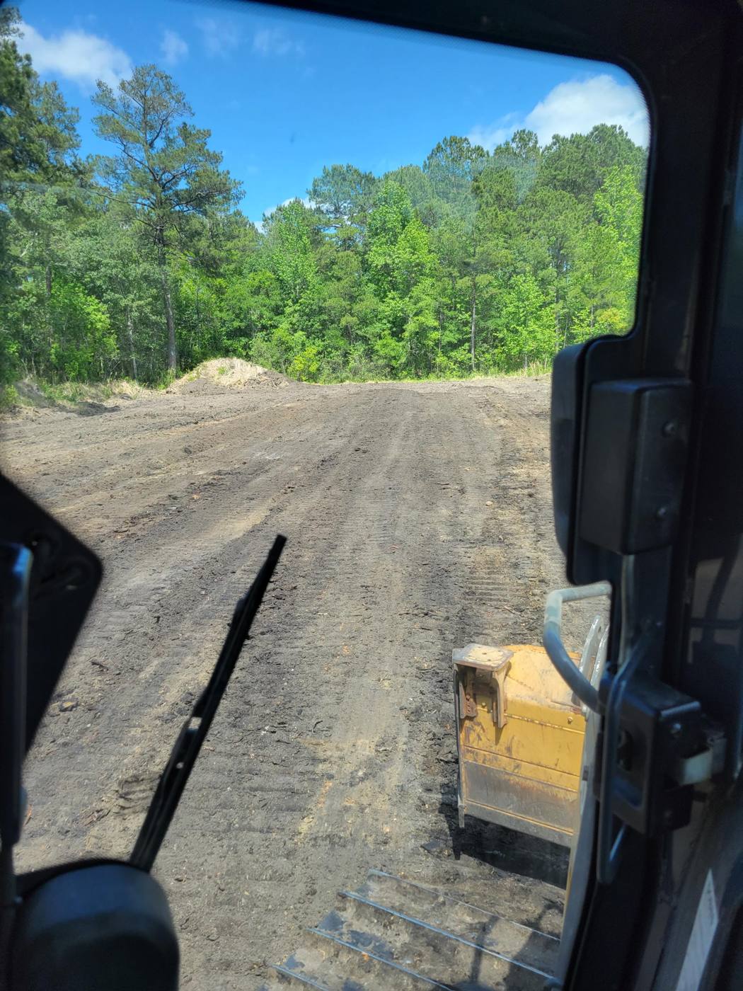 Graded dirt pad seen from the equipment cab