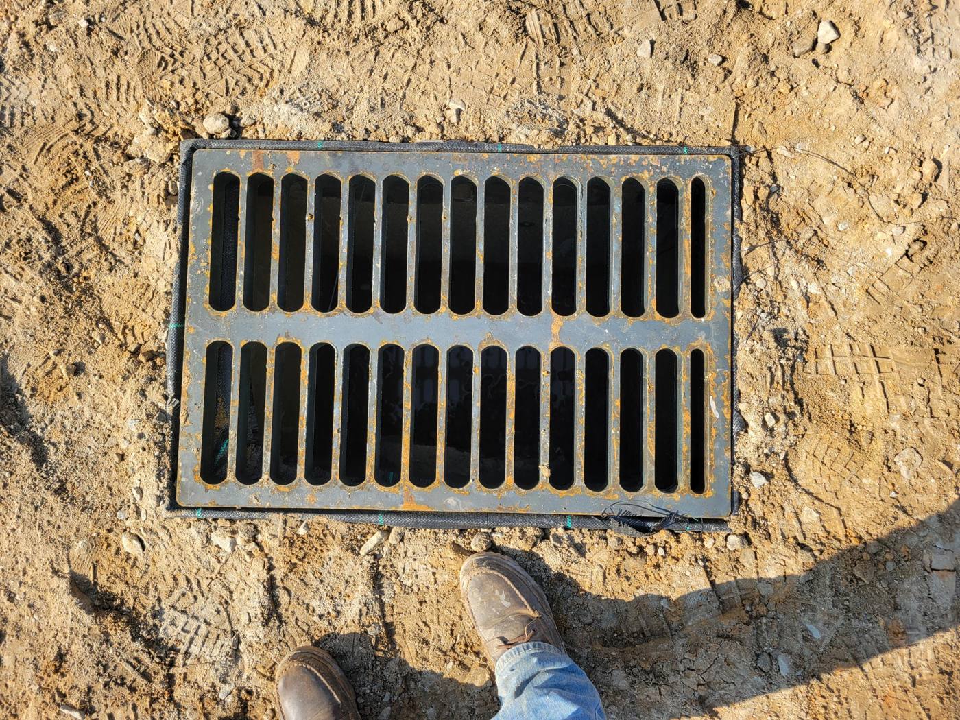 Steel storm drain grate installed at grade