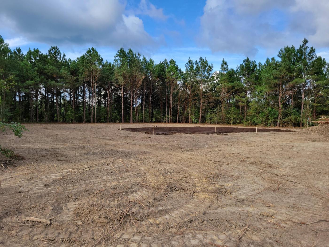 Cleared lot with a staked house pad